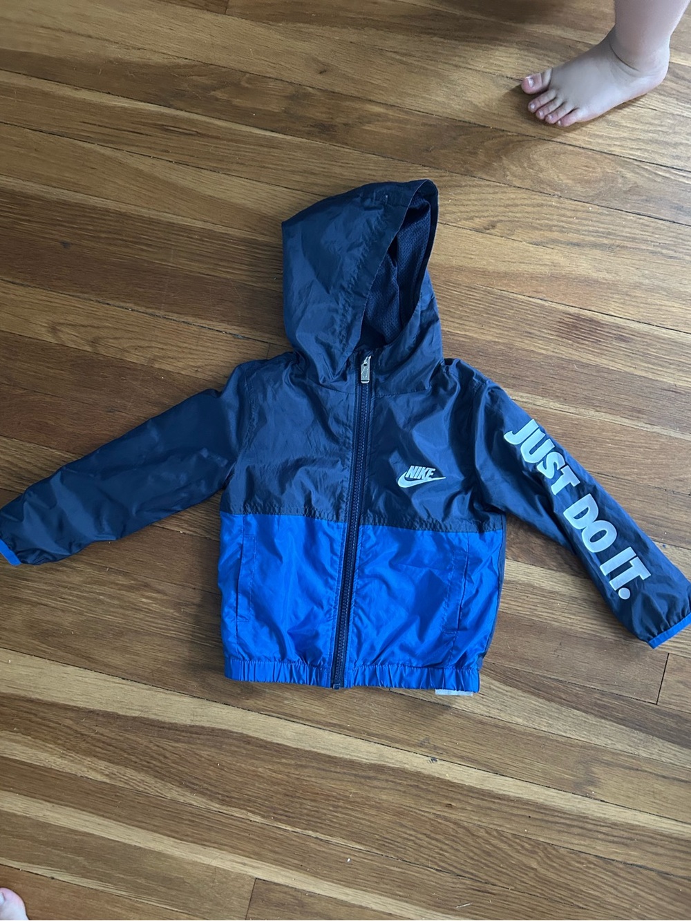 Nike Boys' Navy and Bright Blue Hooded Rain Jacket with 'Just Do It.' Sleeve